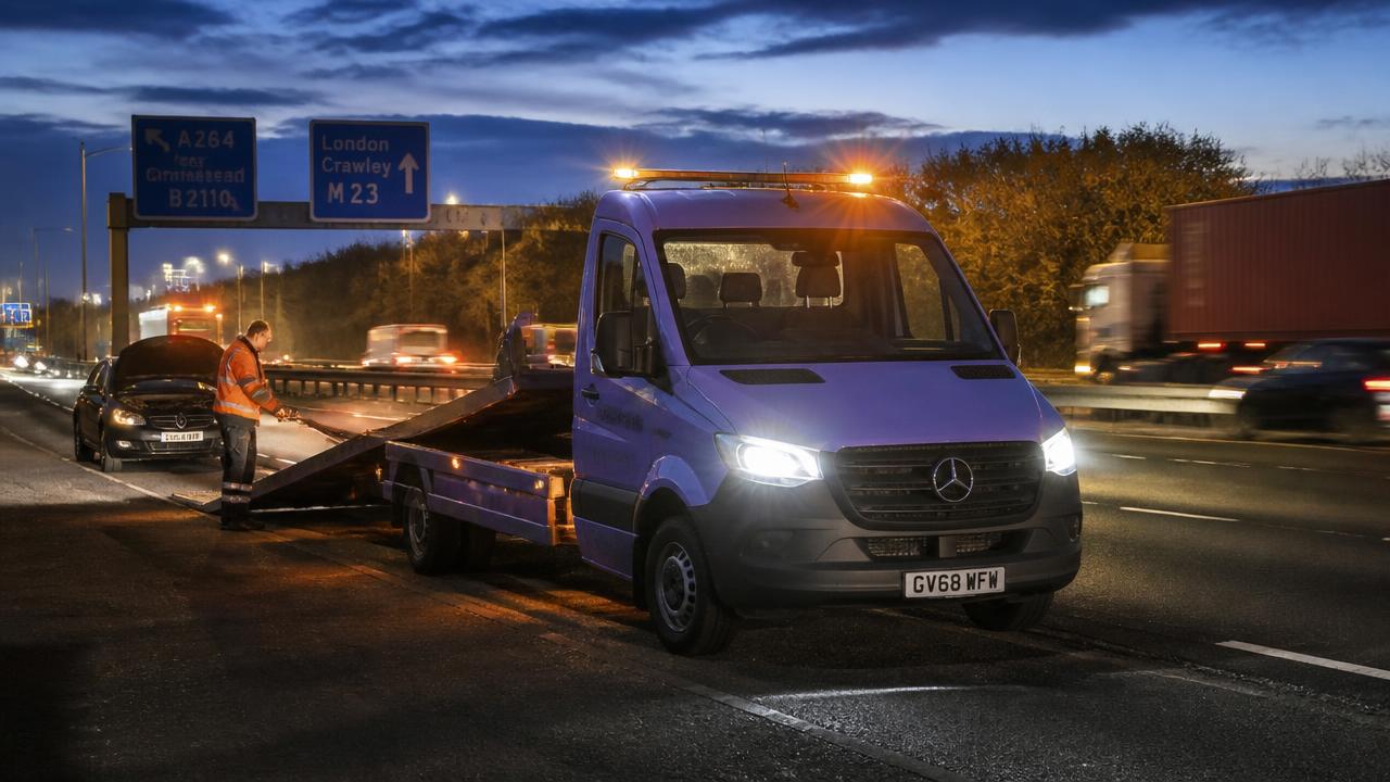 Motorway recovery at dusk on the M1 with beacon lights on